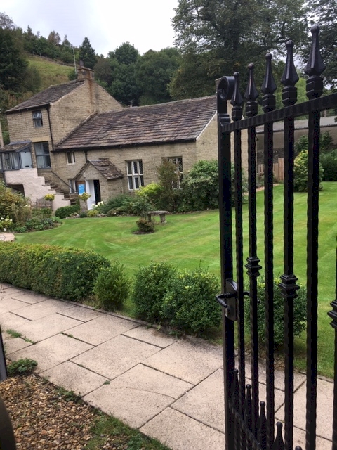 welcome to our Quaker Meeting House viewed from gate and peace garden