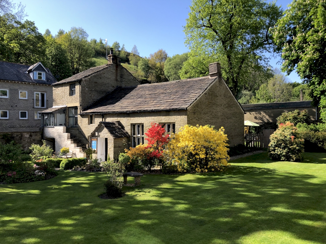 Meeting House and cottage showing garden with azaleas in bloom and lawn in shade